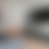 A pixelated grayscale gradient image with no discernible subjects or objects, featuring soft transitions between light gray and dark gray tones.