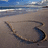 Beach scene with heart drawn in sand and blue background with red text reading "I LUV Quintion".