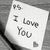 A pixelated grayscale icon shows a white card with text and a heart symbol on a dark background.