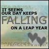 Pixelated static image with text overlay reading 'IT SEEMS OUR DAY KEEPS FALLING ON A LEAP YEAR' and two gray hearts on a blurred background.