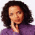 A person with curly dark hair wearing a purple top, hand near face in three showing slight facial expression changes