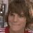 A pixelated image shows a person with brown hair and red clothing on the left, next to blue text reading 'Jens Icons COM' on white background.