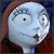 Animated icon featuring Sally from The Nightmare Before Christmas with blue skin, brown hair, and a red dress, alongside promotional text for a Blu-ray and DVD release.