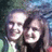 Two pixelated faces in close proximity, one with light hair and the other with dark hair, against a blurred multicolored background.