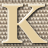 Static 48x48 pixel icon featuring a stylized letter K with beige background and brownish-gray patterned fill, rendered in low-resolution pixel art style.