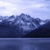 Pixelated landscape with blue-toned water, dark landmasses, and light sky, rendered in low-resolution blocky style.