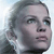 Pixelated static image of a person's face with visible facial features and hair, displayed on a light background.
