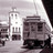 Pixelated grayscale image of a building with a tower and multiple windows, partially obscured by a dark shape on the right.