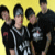 A contact sheet of two animated frames showing four people in black clothing against a yellow background with red text "Good Charlotte Rox!" on the right side.