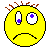 Yellow pixelated face with brown spiky hair, gray eyes containing blue or purple dots, and a mouth transitioning between frown, closed lips, and red tongue across frames.