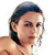 Pixelated close-up of a person with dark hair, light skin, and a neutral expression, cropped to show shoulders and head against a white background.