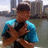 Pixelated image of a person in blue shirt and cap with crossed arms, overlaid with red text fragments on black background.