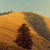 Pixelated landscape with golden-brown terrain, dark tree silhouette, and light blue sky with faint clouds.