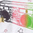 Pixelated static image shows a dark figure with light accents on the left, pink and white abstract shapes in the center, green and brown elements on the right, and small scattered pixels below.