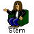 Pixelated cartoon character with long brown hair wearing sunglasses, a green and black jacket over white shirt, blue pants, and brown shoes, seated on gray background with text "Stern" below.