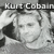 Pixelated grayscale image of a person with short hair, featuring text reading 'Kurt Cobain' above the head, set against a dark background.