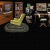 Pixelated static image shows a yellow object on a dark base against a background of brown and gray structures.