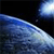 A pixelated image shows a blue and white object resembling a dolphin or whale against a dark background with a bright light source in the upper right.