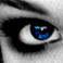 A close-up of a human eye with blue irises, black eyeliner, and visible eyebrow details in grayscale tones.