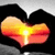 Heart-shaped icon with gradient colors from yellow to red, featuring a bright central light effect against a dark background.