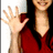 A person in a red top waves with their right hand against a white background, while blue text reads 'hey, im weird and i love it' on the right.
