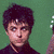 A pixelated image of a person holding a yellow electric guitar against a green background, with visible animation frames showing partial body and instrument details.