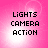 Pixelated text "LIGHTS CAMERA ACTION" on a pink gradient background with white light effects.