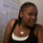A pixelated image of a person wearing a black tank top with white trim, standing against a light gray background.
