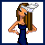 Pixelated animated icon of a woman in a dark blue dress with long brown hair, wearing white shoes and a silver headband, standing with hands on hips.