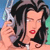 Pixelated image of a person with dark wavy hair holding a silver microphone against a blue and green background.