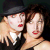 A static image featuring two stylized figures with red lips and a black background, accompanied by golden text reading "the dresden dolls".