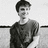 Black-and-white photo of a person in a dark shirt with red text reading 'Harry Potter' and 'is getting HOTTER!' on black background.