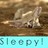 A pixelated static image shows a light-colored animal lying on brown ground with text below.