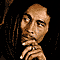 Pixelated static image of a person with long dreadlocks and hand near chin against black background, rendered in brown/peach tones with dithering effects.