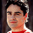 A pixelated image of a person with dark hair wearing a red and white striped shirt against a dark background, next to green text reading 'Original Icons .com' on a solid green backdrop.