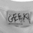 A four-quadrant image with a gray top-left quadrant showing a blurred 'GEEK' label on fabric, white top-right and bottom-left quadrants containing black pixelated text reading 'labels are for shirts' and 'not people', and a solid gray bottom-right quadrant.