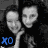 Two grayscale cartoon faces with smooth shading and pixelated edges, one holding a microphone-like object against a dark background with blue text "XD" in the lower left.