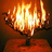 A pixelated static image shows a glowing candelabra with multiple flames against an orange-brown background.