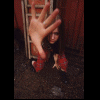 A young woman with long brown hair appears in three : first crouching behind a ladder, then extending her hand forward, and finally facing the camera directly