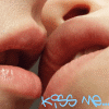 Close-up of lips and nose with blue text 'KISS ME...' at bottom, showing animation change from light to dark blue text.