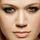 Pixelated close-up of a human face showing eyes, nose, and mouth with neutral expression on light skin tone.