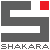 A static icon features a stylized gray 'S' shape with a red square in the top-right corner and pixelated text below reading 'SHAKARA' on a light gray background.