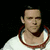 A person in a white shirt with red collar trim appears in six showing sequential hand and facial movements against black background