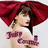 A woman with brown hair and red lipstick wears a large red bow, her shoulder visible under the text "Judy Garland" in purple script.