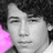 Two side-by-side portrait images of a person with curly hair, one in grayscale and the other in color, below which is text reading NICHOLAS JERRY JONAS <3.