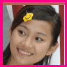 identical small images showing a person with a yellow flower in dark hair, wearing a white top against a red background, with pink borders and a pink Chinese character on some frames