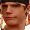 six pixelated images showing a person with light brown hair, black cap, and earrings against a blurred background with red and yellow tones