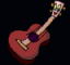 Red acoustic guitar with purple soundhole, light brown neck and headstock featuring small colorful gem-like decorations on a black background.
