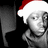 Pixelated grayscale image of a person wearing a red and white Santa hat against black background.